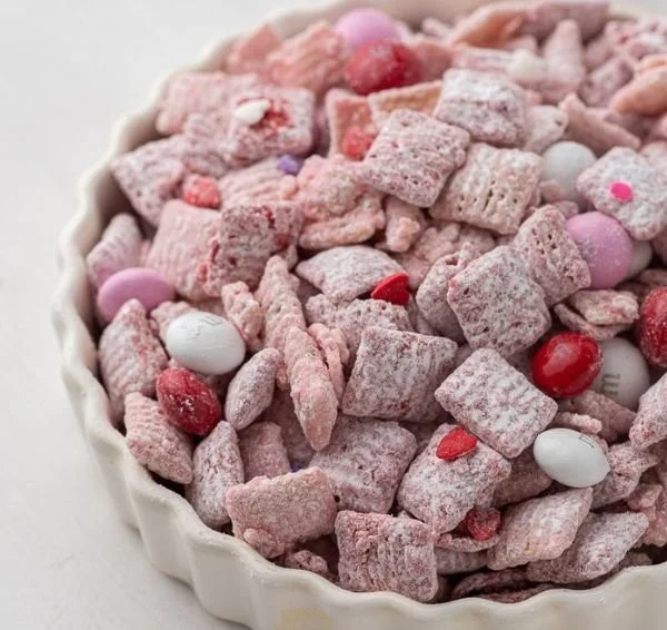 A bowl of tasty Muddy Buddies snack mix made with chocolate and peanut butter.