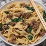 One-Pot Creamy Beef and Spinach Alfredo served in a bowl with fresh spinach