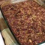 Delicious pecan pie bars topped with caramel and pecans, perfect for dessert.
