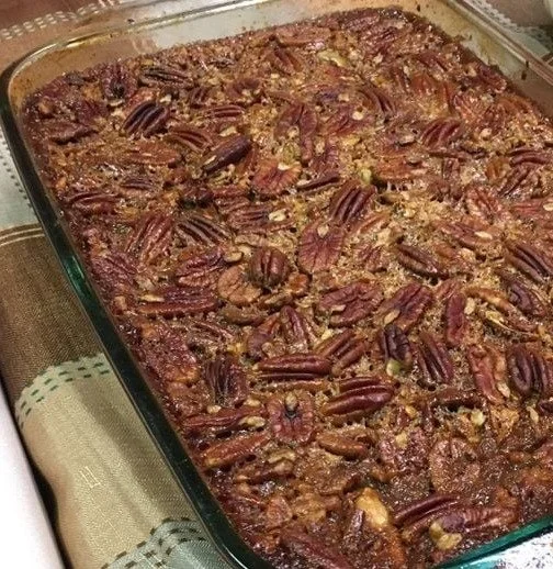 Delicious pecan pie bars topped with caramel and pecans, perfect for dessert.