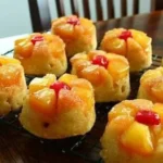 Freshly baked Pineapple Upside-Down Muffins with caramelized pineapple topping