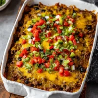 Delicious Beef Burrito Casserole topped with melted cheese and fresh ingredients