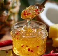 Jar of homemade coconut jam with a spoon