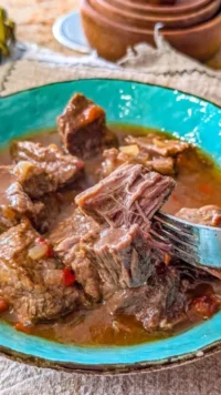 Delicious crockpot pepper steak served with green peppers and rice.