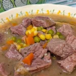 Bowl of easy beef stew with vegetables and herbs