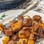 Plate of fried potatoes with onions and Polish sausage, a hearty meal option