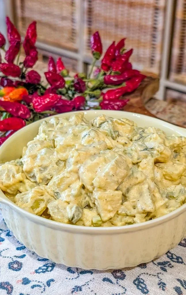 Delicious Southern potato salad in a bowl with parsley garnish