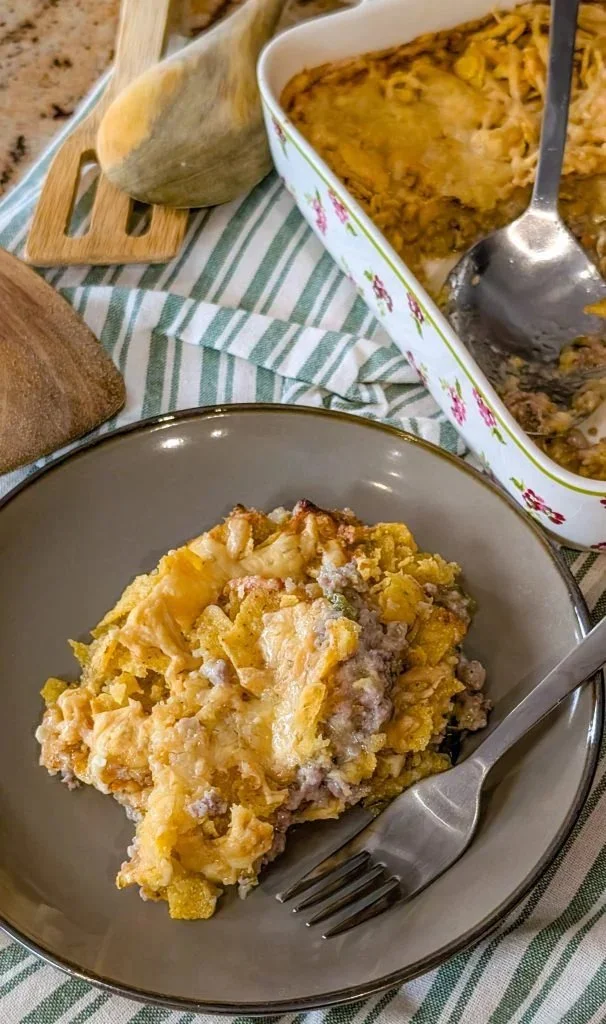 Delicious Walking Taco Casserole topped with cheese and fresh toppings.
