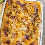 Delicious warm cheesy potato sausage casserole in a baking dish