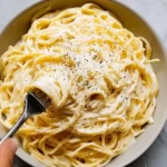 Baked Cream Cheese Spaghetti Delight topped with herbs and cheese