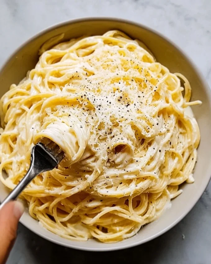 Baked Cream Cheese Spaghetti Delight topped with herbs and cheese