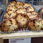 Freshly baked chocolate chip muffins on a cooling rack