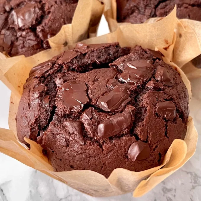 Delicious freshly baked chocolate chunk muffins with melting chocolate pieces