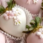 Delicious chocolate covered strawberries drizzled with white chocolate on a platter