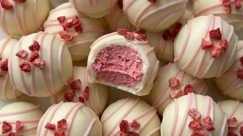 Creamy strawberry white chocolate truffles with fresh strawberries and cocoa