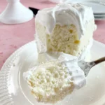 Deliciously moist favorite white cake with icing and decorative toppings