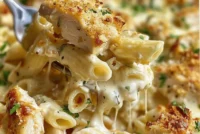 Baked Garlic Parmesan Chicken with pasta, cheese, and herbs in a casserole dish