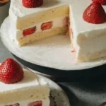 Slice of Japanese Strawberry Cake topped with fresh strawberries and whipped cream
