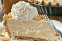 Delicious Root Beer Float Pie topped with whipped cream and root beer syrup.