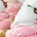 Delicious white chocolate covered strawberry cupcakes on a plate