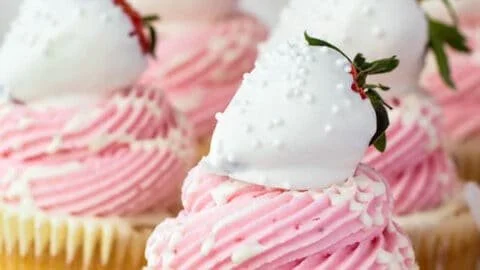 Delicious white chocolate covered strawberry cupcakes on a plate