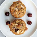 Almond Cherry Muffins with chia seeds on a wooden table