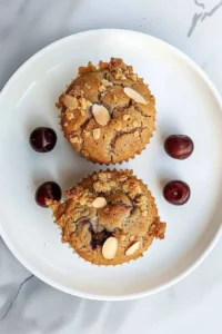 Almond Cherry Muffins with chia seeds on a wooden table