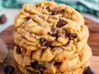 Chewy peanut butter chocolate chip cookies on a baking tray