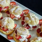 Delicious creamy strawberry profiteroles topped with fresh strawberries
