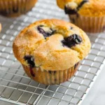 Freshly baked blueberry muffins on a cooling rack