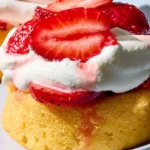 Freshly made simple strawberry shortcake with whipped cream and strawberries