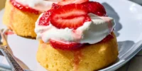 Freshly made simple strawberry shortcake with whipped cream and strawberries
