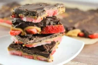 Delicious Strawberry-Chocolate Bark topped with red strawberries and drizzled chocolate