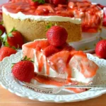 Unbaked strawberry cheesecake topped with fresh strawberries